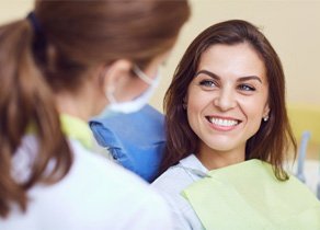 Young woman speaking to her dentist