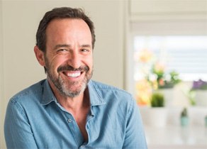 man in light blue button up shirt smiling