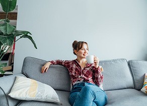 Woman resting on her sofa, taking it easy at home