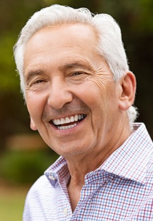 Senior man in button up shirt smiling