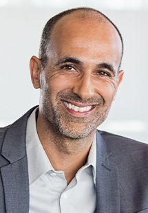 Man in grey suit smiling