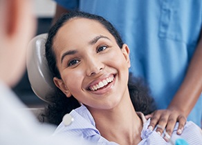 Patient smiling while sitting in dentist's treatment chair