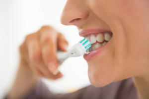 a young woman brushing her teeth